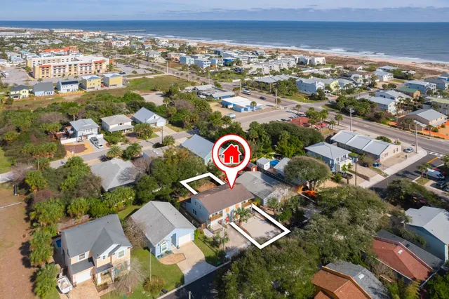 an aerial view of residential houses with outdoor space