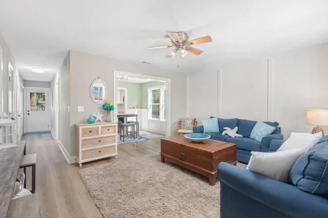 a living room with furniture and view of kitchen