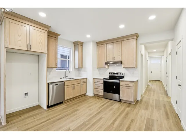 a view of a kitchen with wooden floor