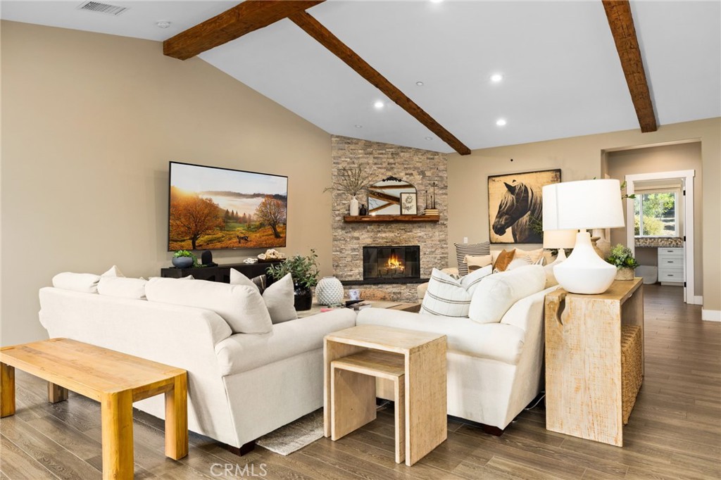 4007 Ladera Vista Road Fallbrook, CA 92028 - Photo 11 of 64 a living room with furniture a flat screen tv and a fireplace