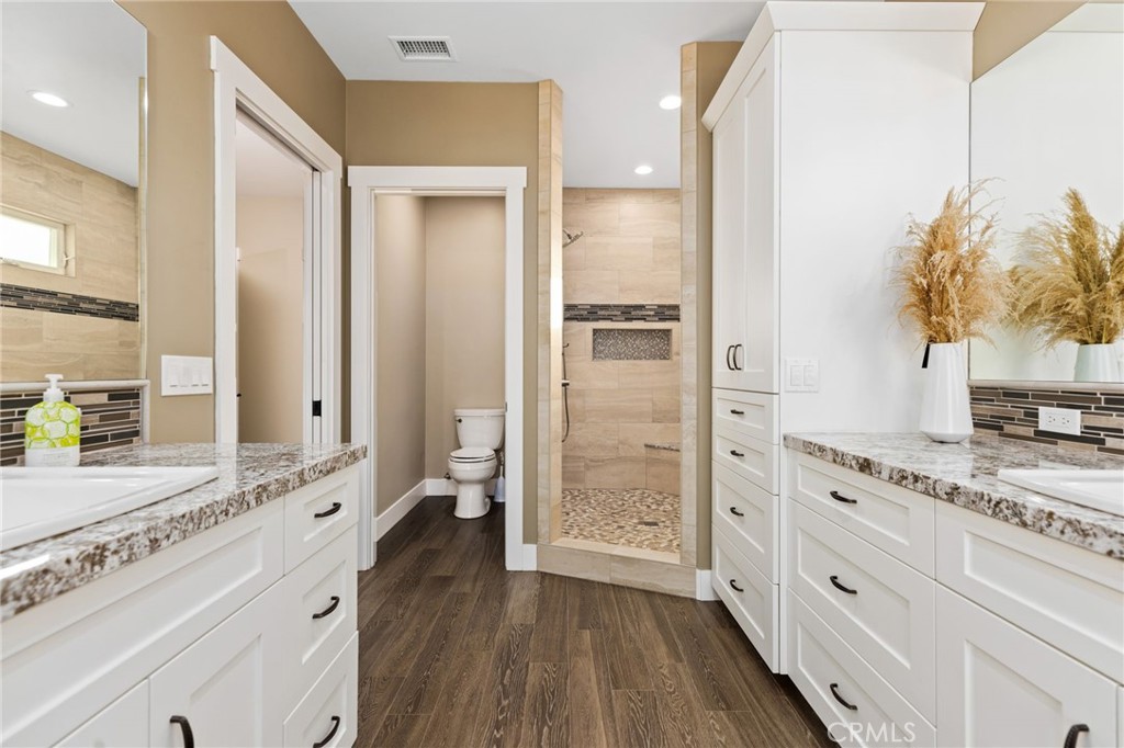 4007 Ladera Vista Road Fallbrook, CA 92028 - Photo 21 of 64 a spacious bathroom with a granite countertop sink mirror and shower