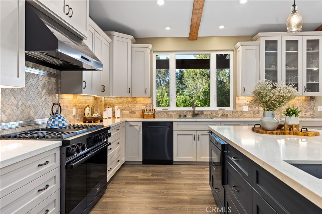4007 Ladera Vista Road Fallbrook, CA 92028 - Photo 5 of 64 a kitchen with a sink stove and cabinets