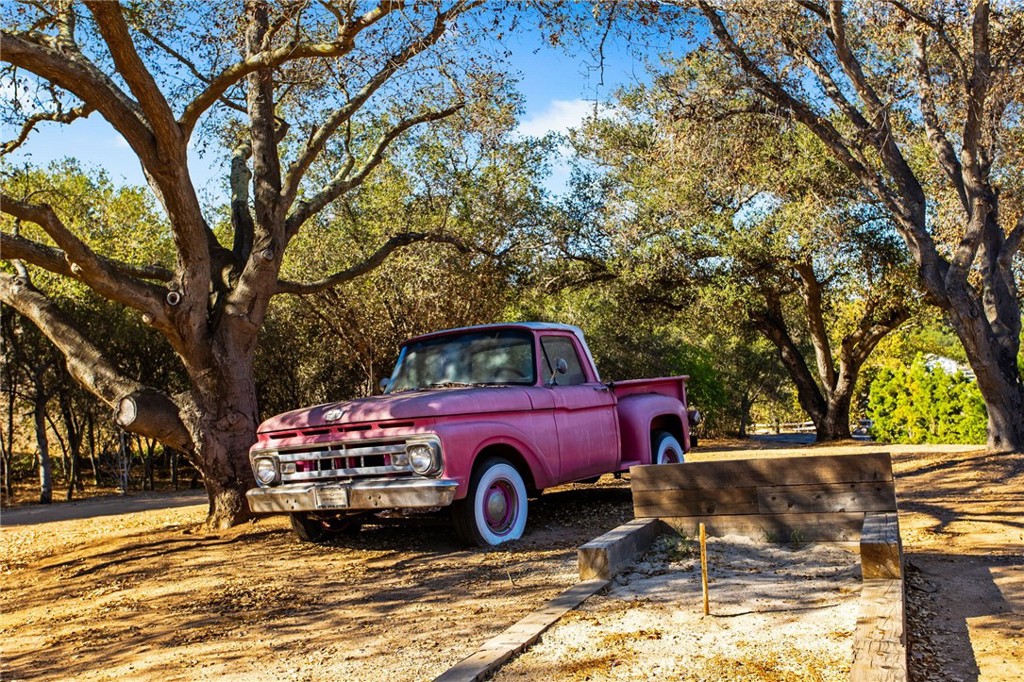 4007 Ladera Vista Road Fallbrook, CA 92028 - Photo 51 of 64 a view of a red car in front of a house