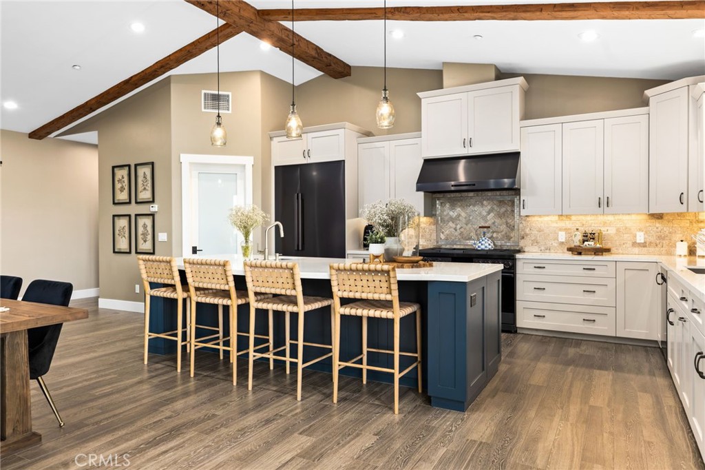 4007 Ladera Vista Road Fallbrook, CA 92028 - Photo 6 of 64 a kitchen with stainless steel appliances kitchen island granite countertop a table chairs sink and cabinets