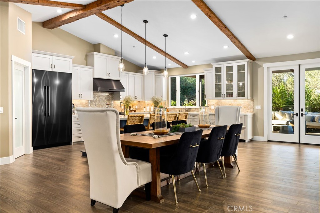 4007 Ladera Vista Road Fallbrook, CA 92028 - Photo 7 of 64 a dining room with stainless steel appliances kitchen island granite countertop a table chairs and a dining table
