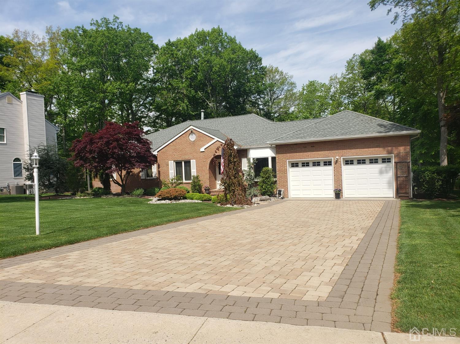 41 Dundee Road Kendall Park, NJ 08824 - Photo 2 of 42 a front view of a house with a yard and garage