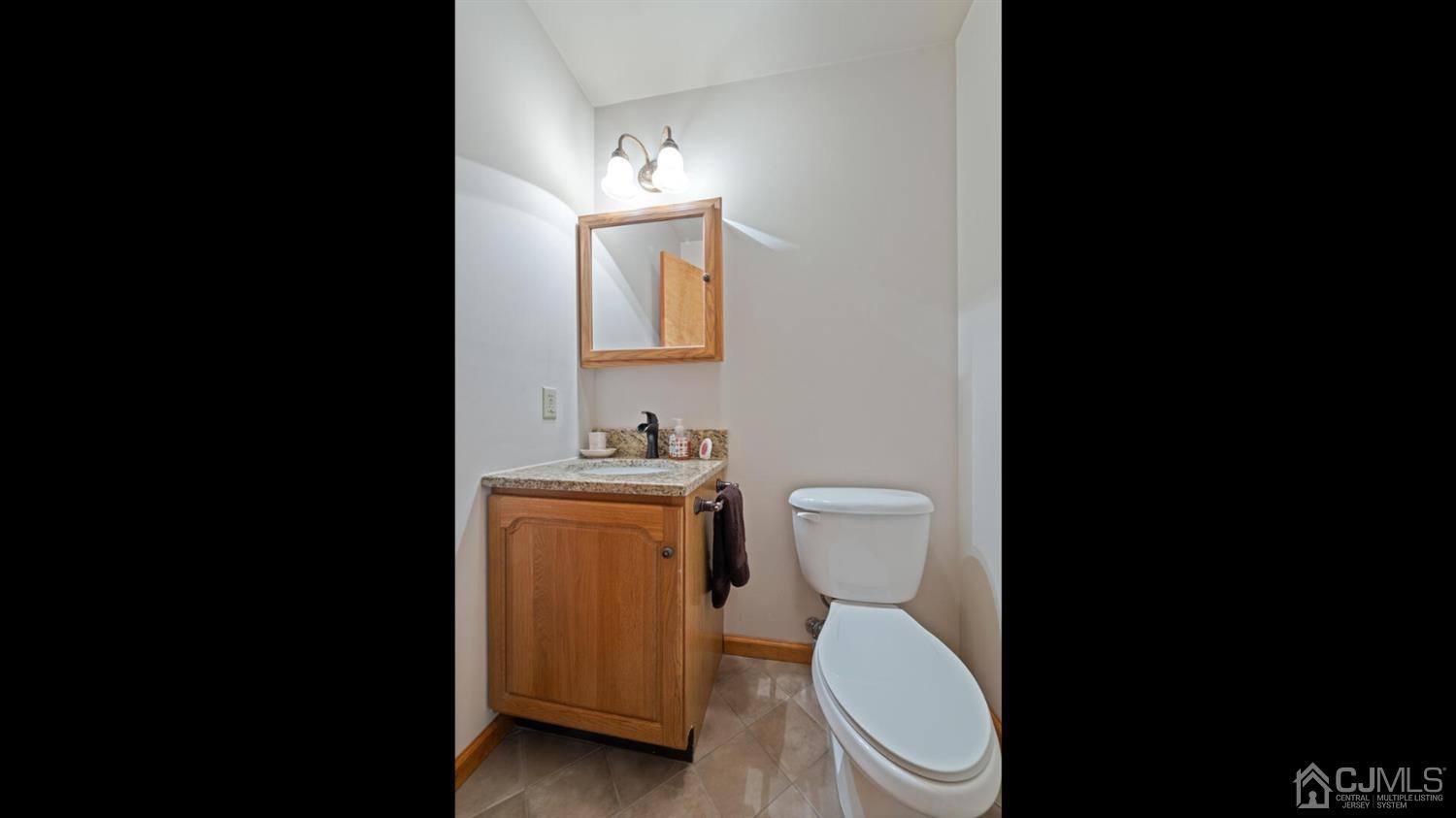 41 Dundee Road Kendall Park, NJ 08824 - Photo 23 of 42 a white toilet sitting next to a bathroom sink