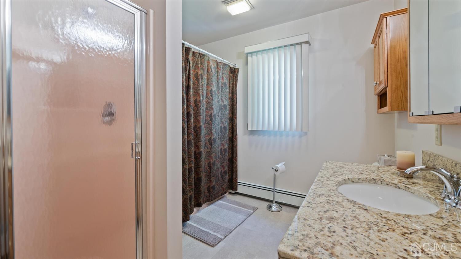 41 Dundee Road Kendall Park, NJ 08824 - Photo 28 of 42 a bathroom with a sink and a mirror