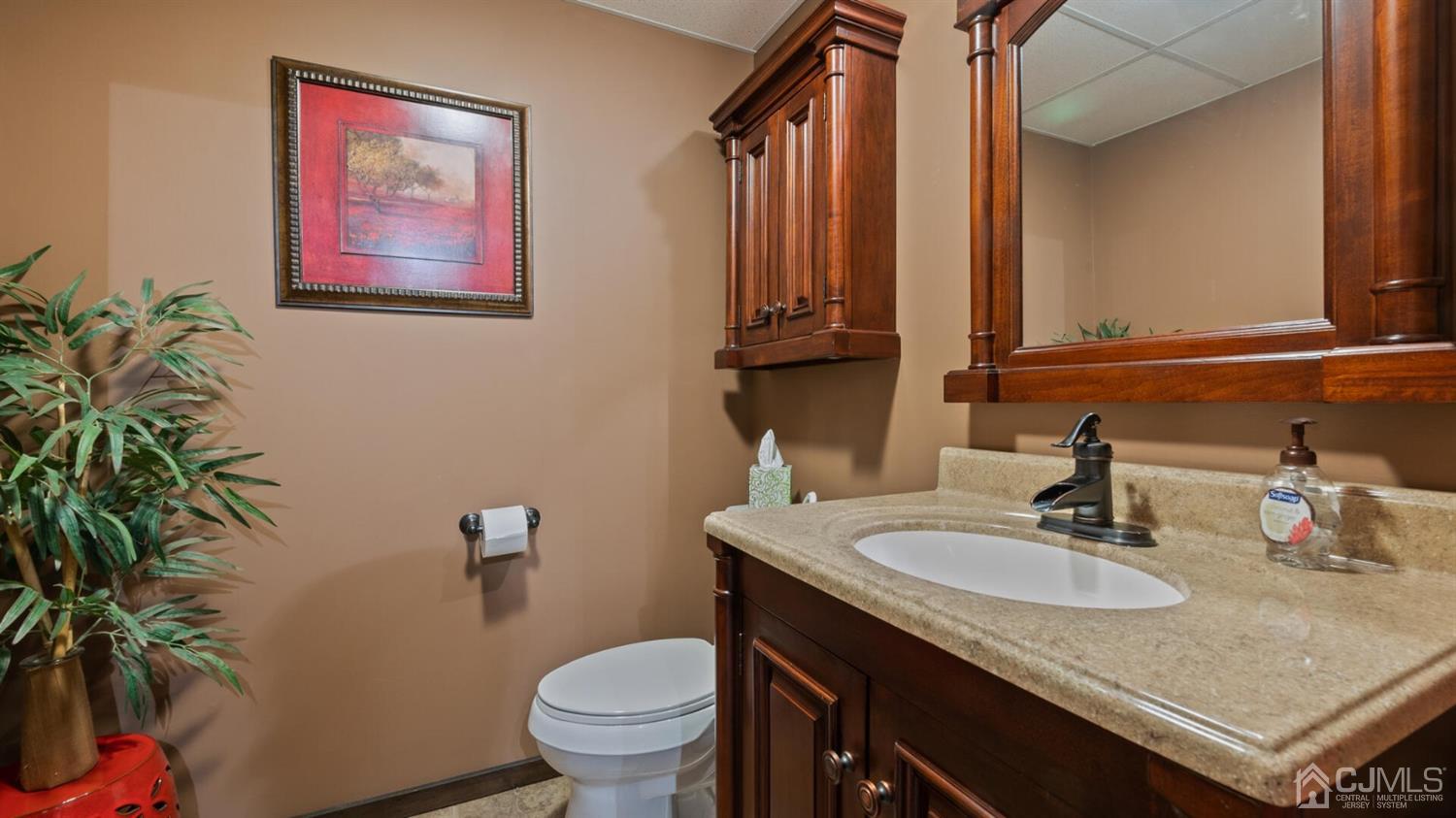 41 Dundee Road Kendall Park, NJ 08824 - Photo 30 of 42 a bathroom with a granite countertop sink and a toilet