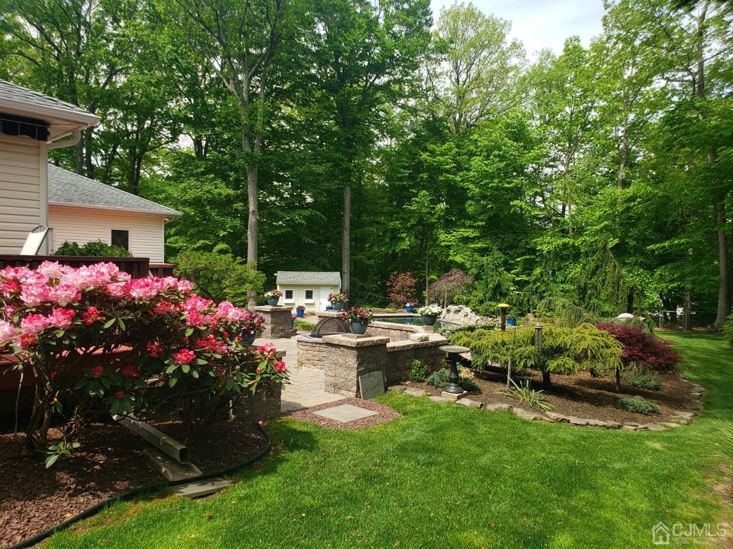 41 Dundee Road Kendall Park, NJ 08824 - Photo 4 of 42 a view of a backyard with sitting area and garden