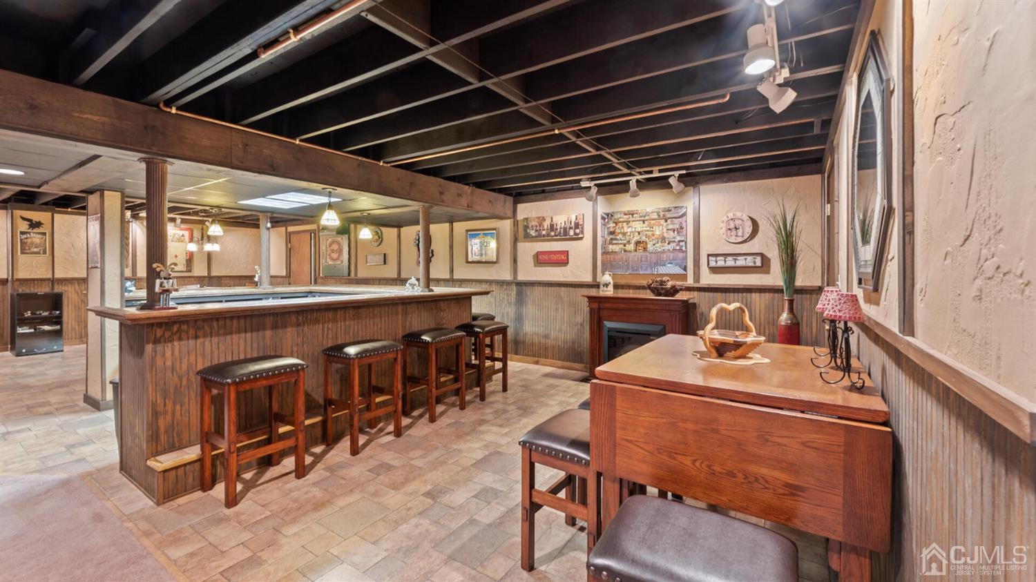 41 Dundee Road Kendall Park, NJ 08824 - Photo 32 of 42 a room with stainless steel appliances kitchen island granite countertop a table chairs and a wooden floor
