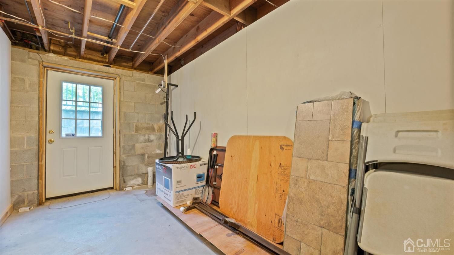 41 Dundee Road Kendall Park, NJ 08824 - Photo 37 of 42 a view of a storage & utility room with washer and dryer