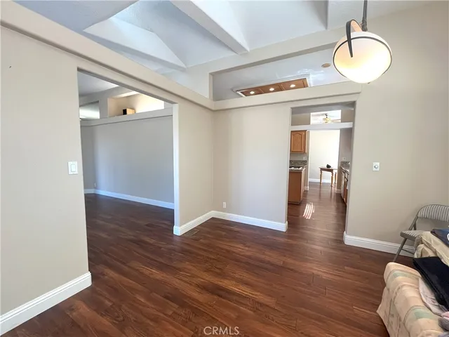 a kitchen with stainless steel appliances granite countertop a stove a sink dishwasher and a refrigerator with wooden cabinets