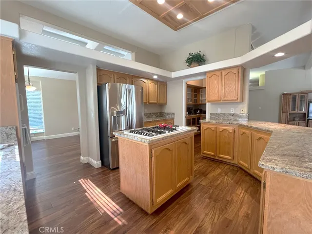 a kitchen with stainless steel appliances granite countertop a refrigerator and a stove