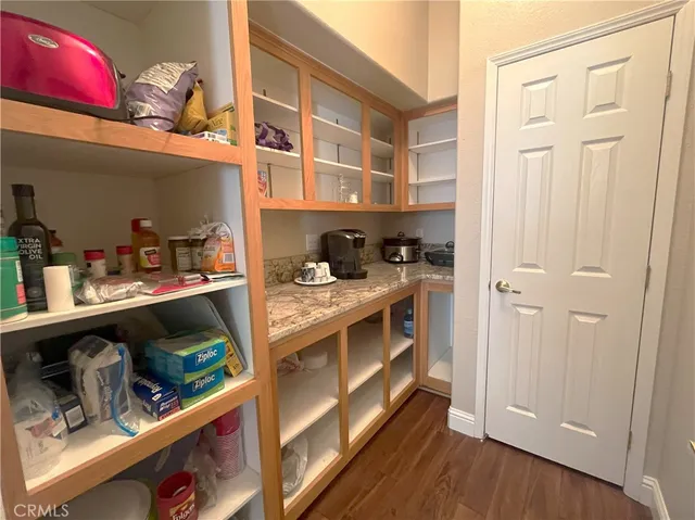 a view of a room with wooden floor water heater and table