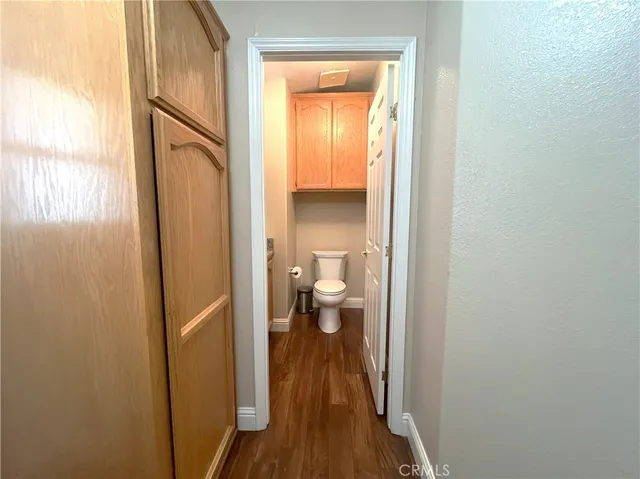 a bathroom with a granite countertop toilet a sink and a mirror