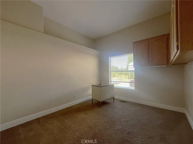 a bathroom with a granite countertop double vanity sink and mirror