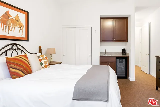 a bedroom with a bed and a mirror