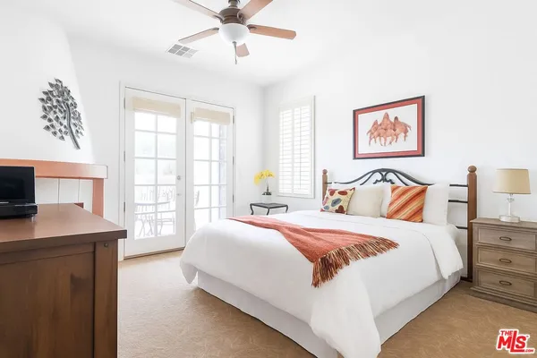 a bedroom with a large bed and a window