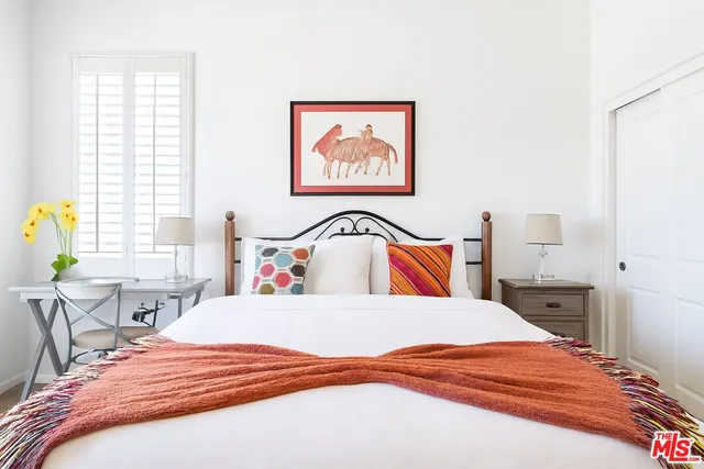 a bedroom with a bed and a large dresser