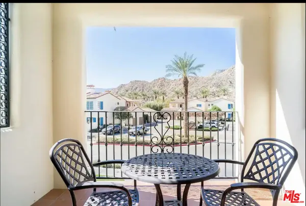 a view of a chair and table in the balcony