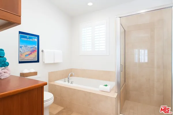 a bathroom with a bathtub a shower and a sink