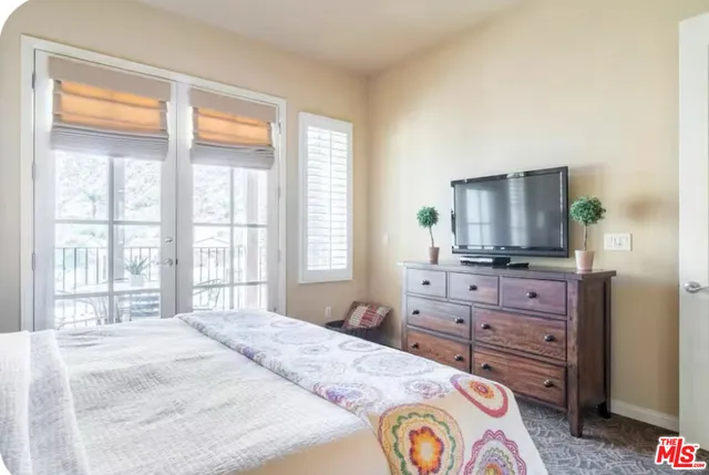 a bedroom with a bed and a dresser in it