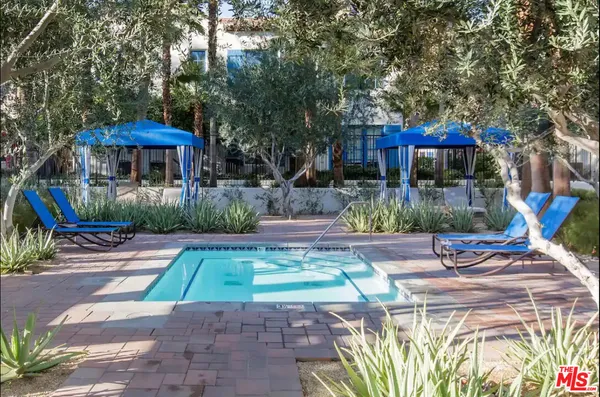 a view of a table and chairs under an umbrella