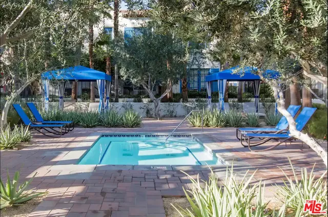 a view of a table and chairs under an umbrella