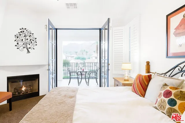 a bedroom with a bed and a fireplace