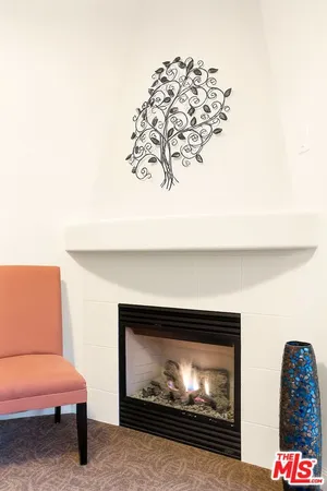 a room with a fireplace and a painting on the wall