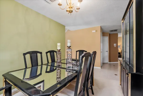 a dining room with furniture and a chandelier
