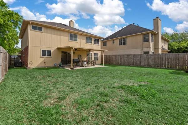 a view of a house with a yard and sitting area