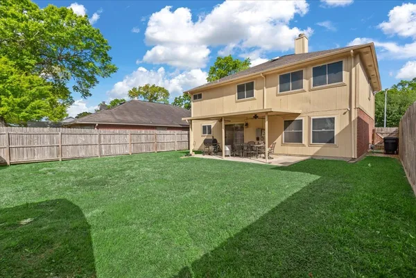 a view of a house with a backyard