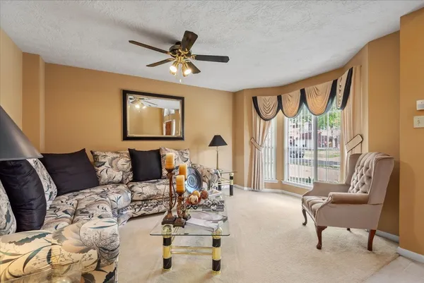 a living room with furniture and a large window