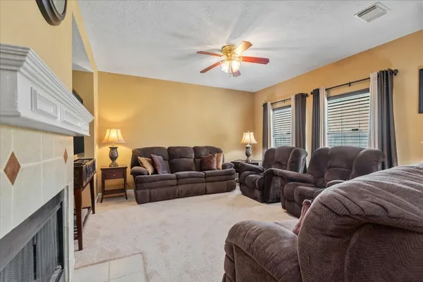 a living room with furniture a chandelier and a window