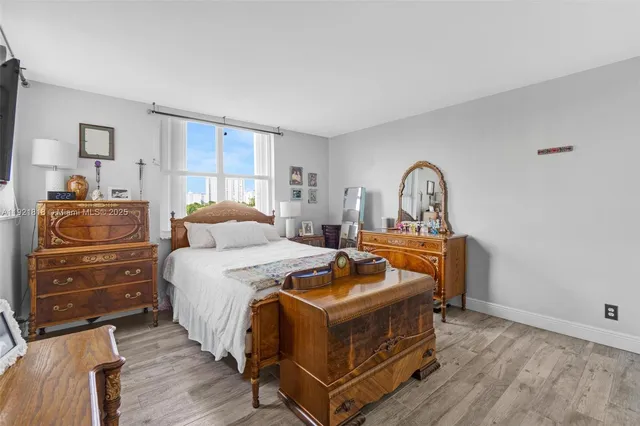 a bed room with a bed and a dresser