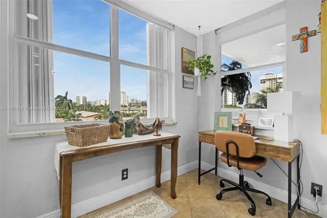 a view of a workspace with furniture and a potted plant