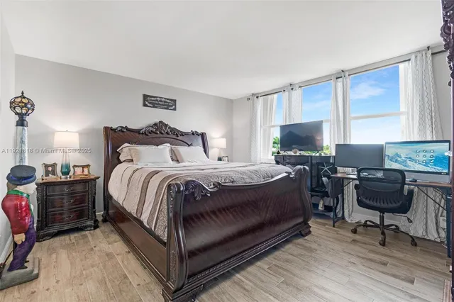 a bedroom with a bed and a large mirror