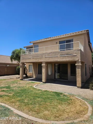 a view of a house with backyard porch and sitting area
