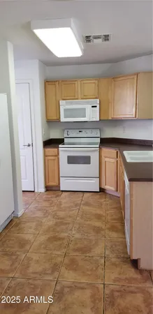a kitchen with granite countertop a stove and a sink