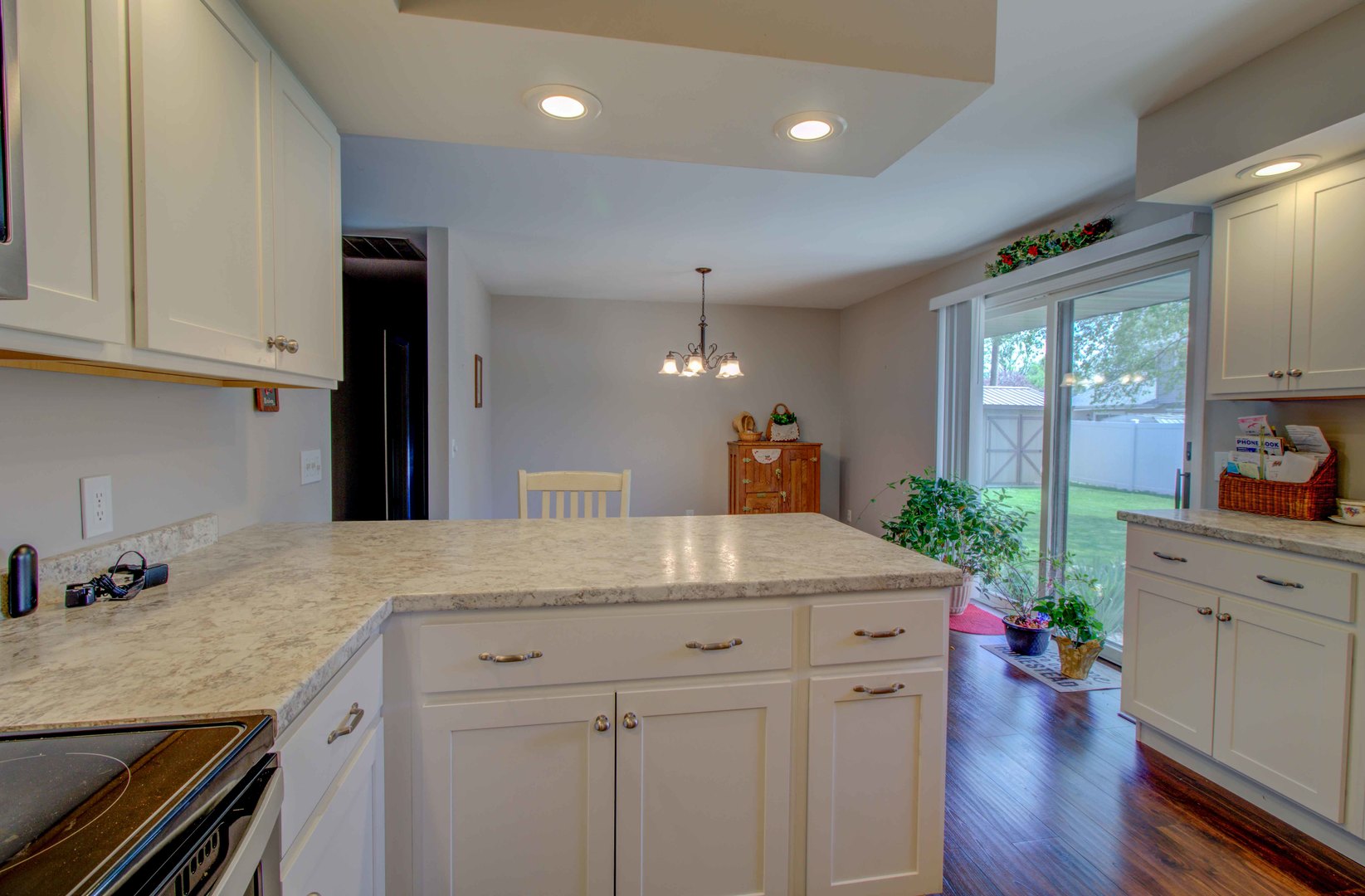 217 Eldorado Drive Tuscola, IL 61953 - Photo 13 of 26 a kitchen with a sink dishwasher and white cabinets with wooden floor