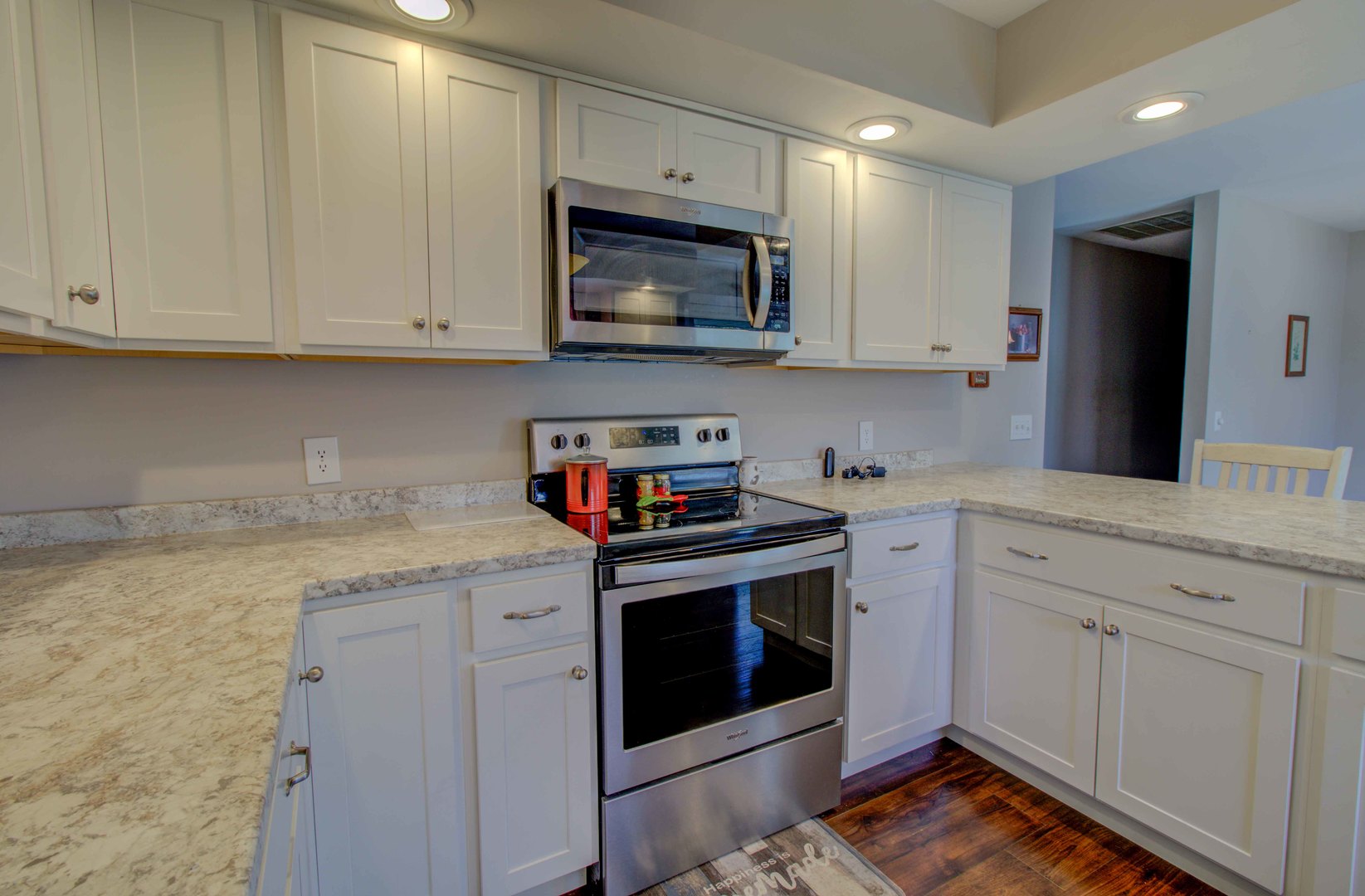 217 Eldorado Drive Tuscola, IL 61953 - Photo 16 of 26 a kitchen with granite countertop white cabinets and stainless steel appliances