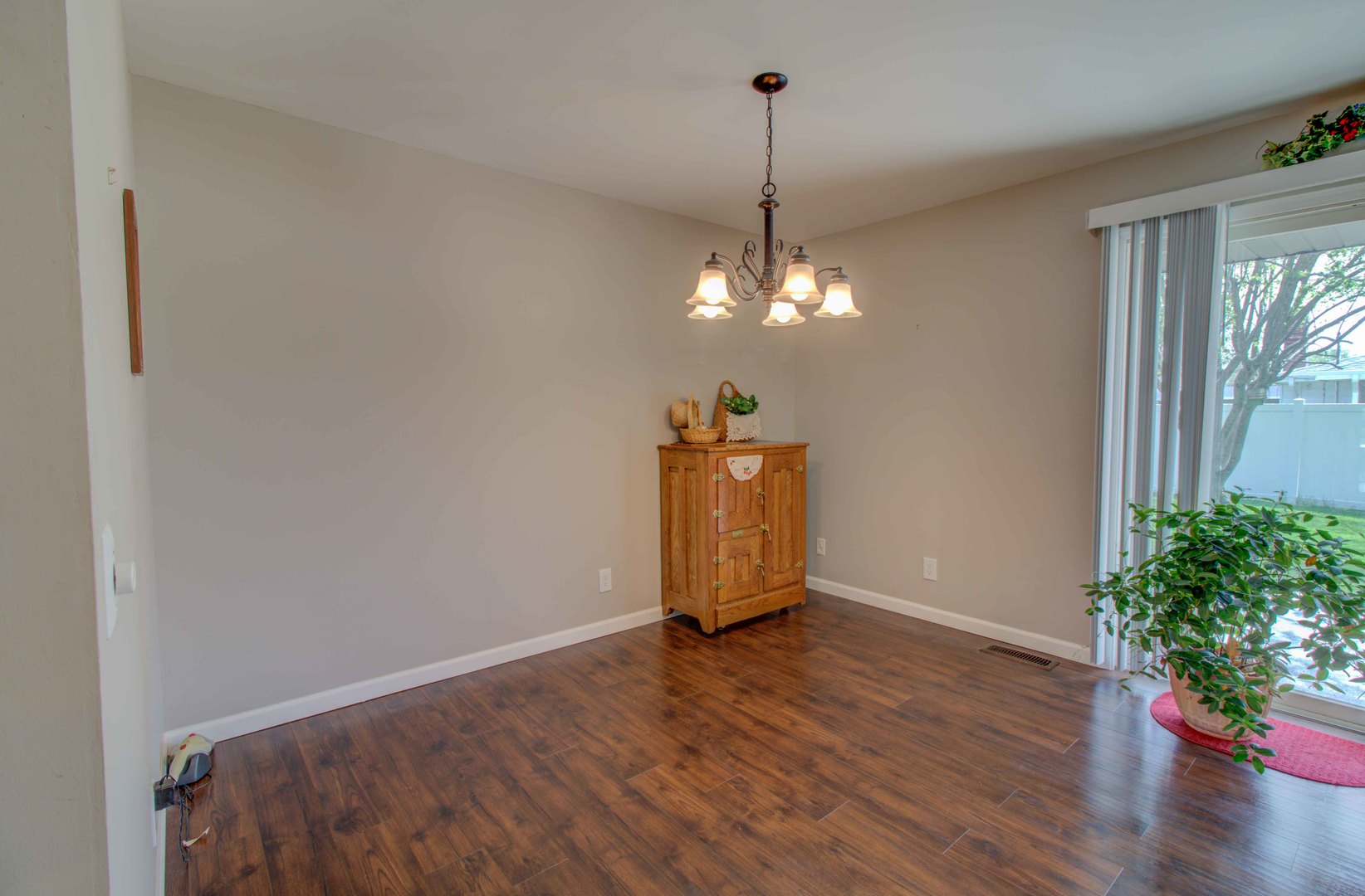 217 Eldorado Drive Tuscola, IL 61953 - Photo 18 of 26 a view of a room with wooden floor potted plants and a chandelier