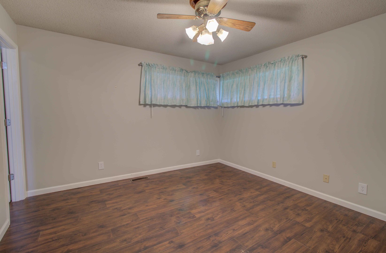 217 Eldorado Drive Tuscola, IL 61953 - Photo 22 of 26 a view of an empty room with a window and wooden floor