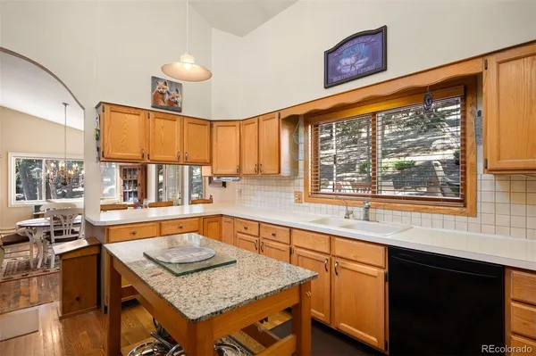 a kitchen with a stove a sink and a wooden cabinets