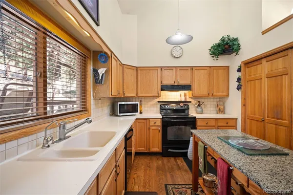 a kitchen with a stove a sink and a refrigerator