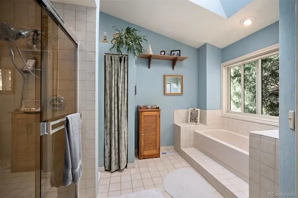 a bathroom with a tub and shower