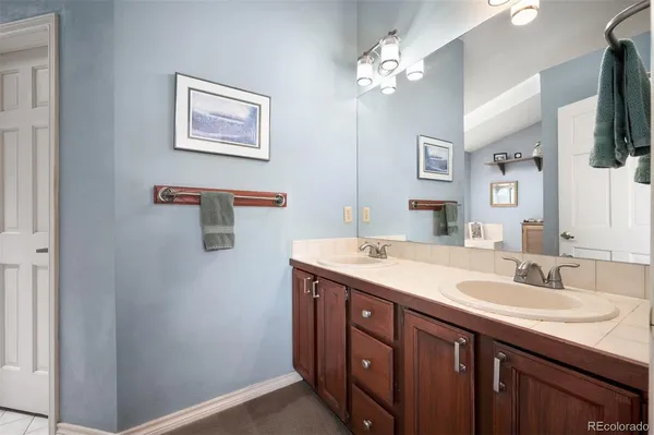 a bathroom with a double vanity sink and a mirror