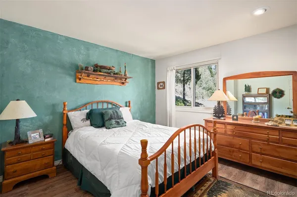 a bedroom with furniture and a large window